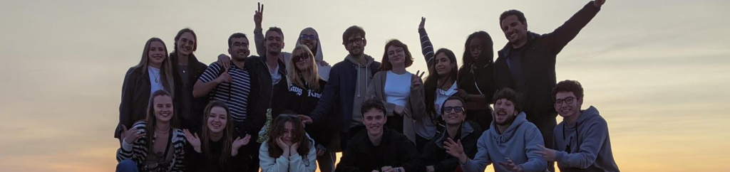 Groupe de volontaires sur la plage, devant le coucher de soleil